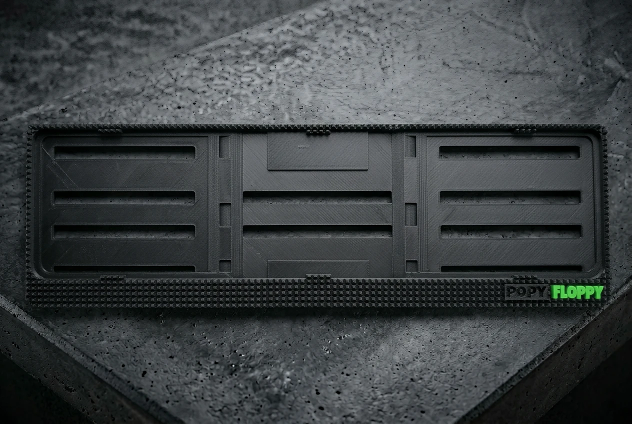 Pyramid number plate underlay — flat product view showing raised pyramidal texture border and Popy Floppy branding